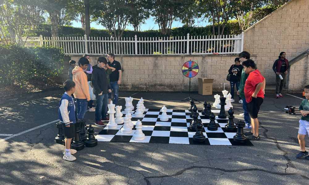 Giant outdoor chess game demonstrating chess science at CHESSKLUB.
