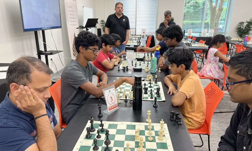 Chess players participating in CHESSKLUB's international chess day tournament