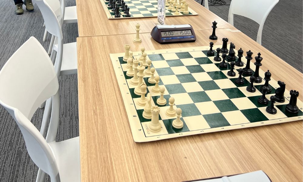 A professional chess game setup for CHESSKLUB students at the academy.