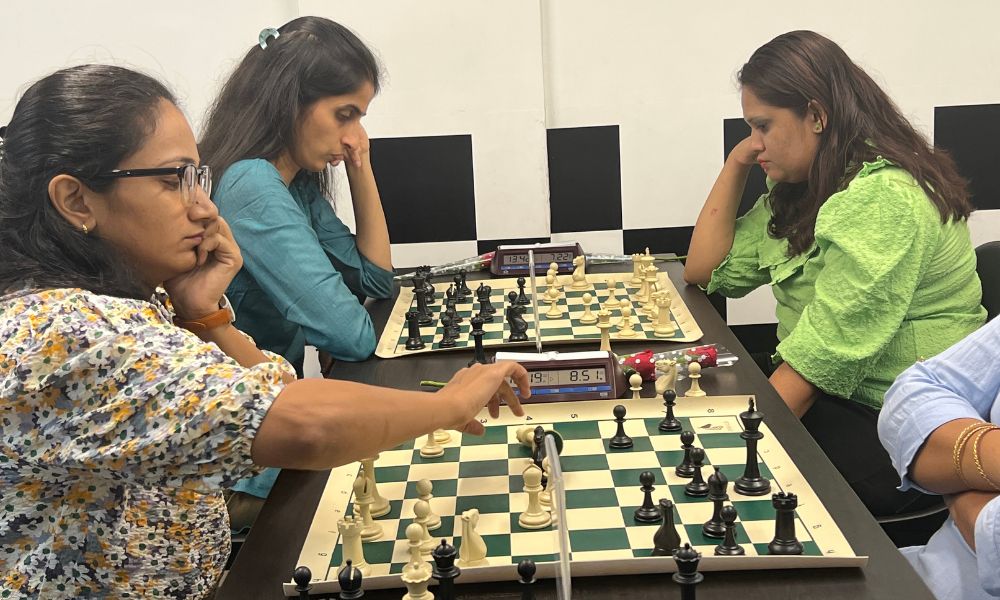 CHESSKLUB players focused on strategy during a game.