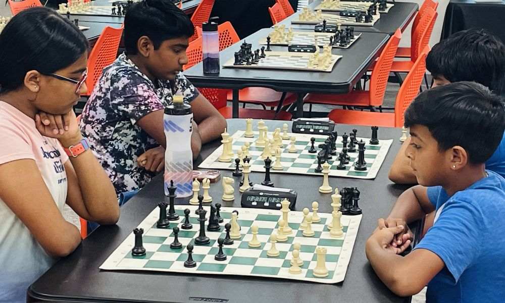 CHESSKLUB students learning and playing chess in a classroom tournament setting