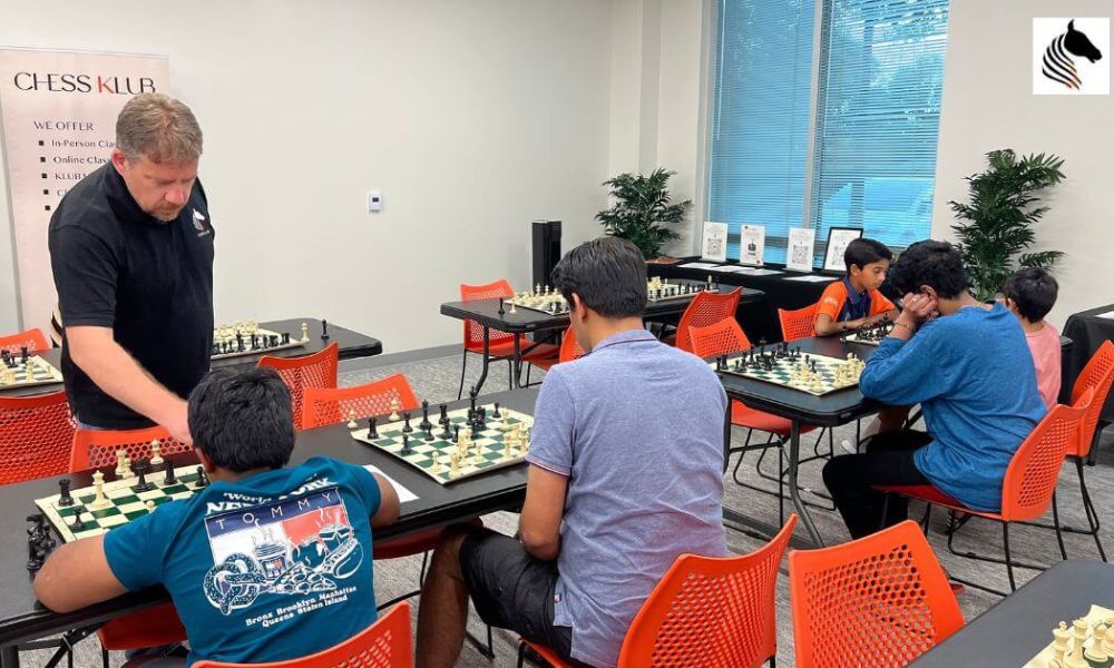 A CHESSKLUB student receiving mentorship during a chess game