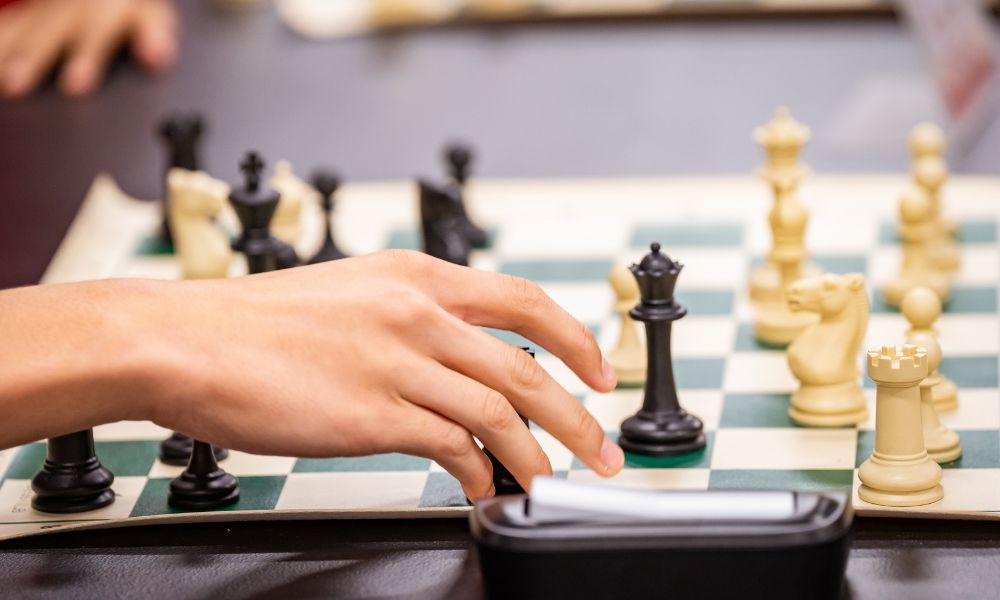 CHESSKLUB student learning the basics of a chess game using a beginner's guide to mastery