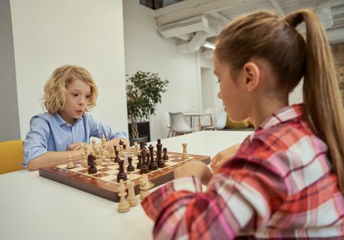 Image representing kids playing chess at school