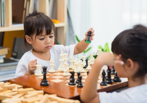 Image of two pre-school kids playing chess