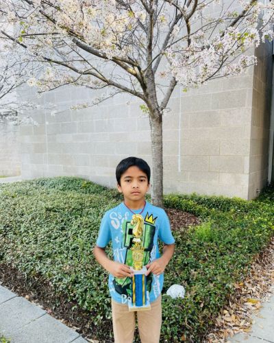 CHESS KLUB Student with Trophy